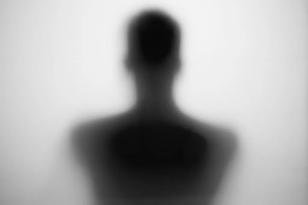 Soft silhouette of a head and shoulders seen from behind
